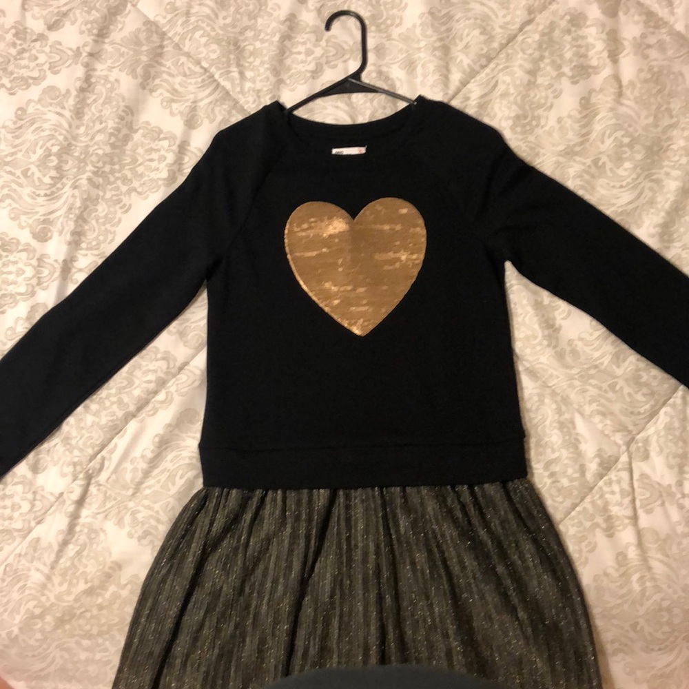 this is a black dress with a golden heart